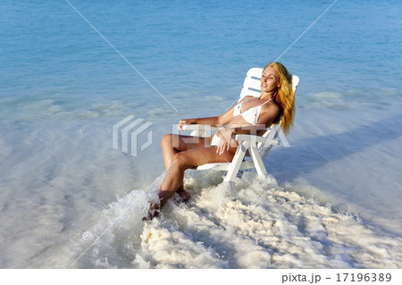 Young pretty woman in a beach chair in sea Young pretty woman in a beach chair in sea 17196389