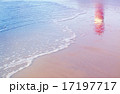 lighthouse reflection among sea waves on beach 17197717