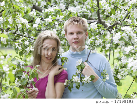 Happy man and the woman in blossoming apple-trees Happy man and the woman in blossoming apple-trees 17198193
