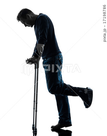 injured man walking sad with crutches silhouette injured man walking sad with crutches silhouette 17198786