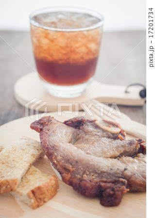 Pork steak on wooden plate Pork steak on wooden plate 17201734