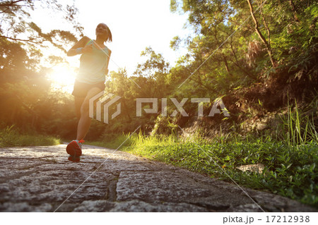 Runner athlete running on forest trail.   17212938
