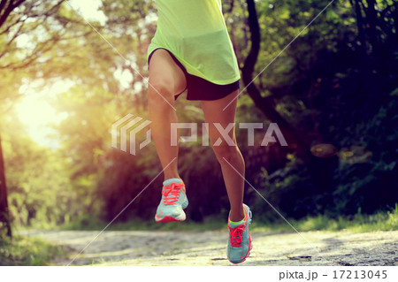 Runner athlete running on forest trail.  17213045