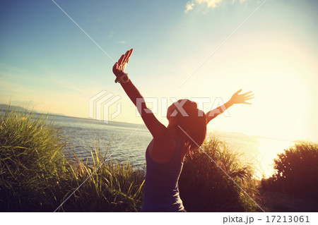 cheering woman jogger open arms at sunrise seaside 17213061