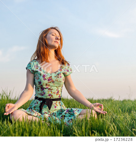 Pretty woman meditate in the park Pretty woman meditate in the park 17236228