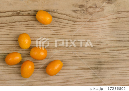 Oval Kumquats On Old Spruce Wood Board 17236802