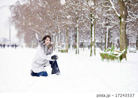 Girl enjoying rare snowy winter day in Paris 17243537