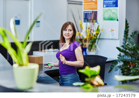 Beautiful young receptionist at work Beautiful young receptionist at work 17243579