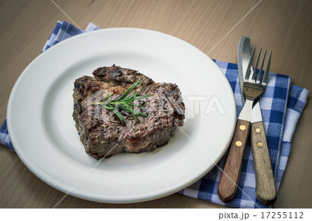 Juicy grilled rib eye steak with cutlery, top view Juicy grilled rib eye steak with cutlery, top view 17255112