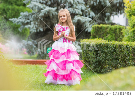 Girl princess stands on the lawn in the green garden 17281403