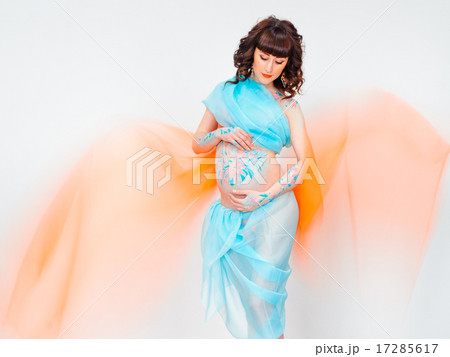 Young pregnant woman with bodyart on her belly 17285617