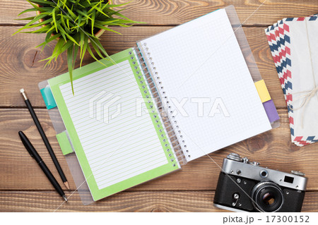 Office desk with notepad, camera, supplies 17300152