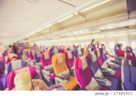 Blurred image Interior of airplane with passengers on seats 17305422