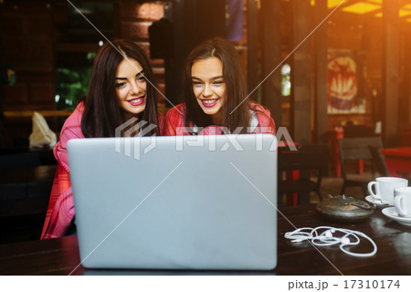 two girls watching something in laptop two girls watching something in laptop 17310174