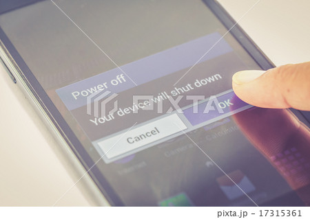 finger press power off button on smartphone 17315361