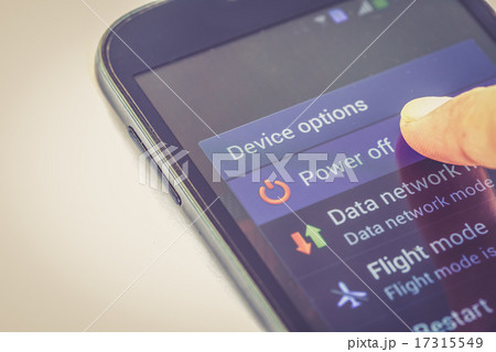 finger press power off button on smartphone 17315549