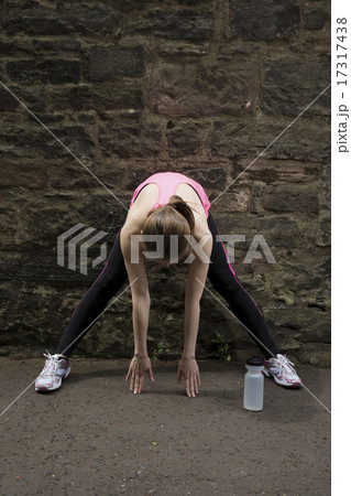 Sporty woman stretching before or after training. 17317438