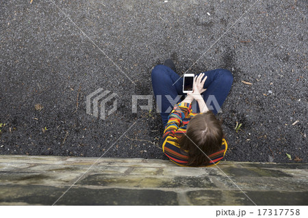 Overhead view of a young woman using a Smartphone. Overhead view of a young woman using a Smartphone. 17317758