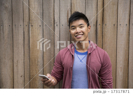 Asian Man using Smart Phone outdoors. 17317871