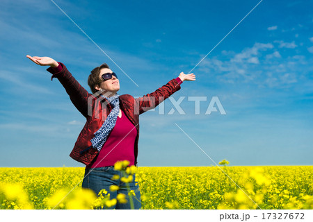 woman in yellow field of rapeseed 17327672