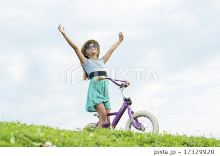 Beautiful portrait of a little girl outside on grass 17329920