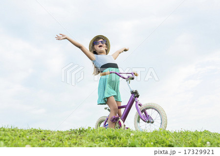 Beautiful portrait of a little girl outside on grass 17329921