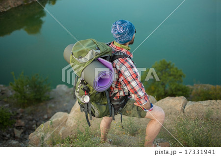 Young caucasian man with backpack on the top of hill 17331941