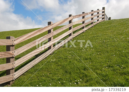 Wooden fence on a dyke. Wooden fence on a dyke. 17339219