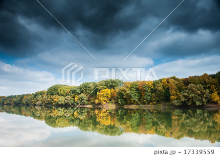 beautiful river and forest with dark sky in autumn 17339559