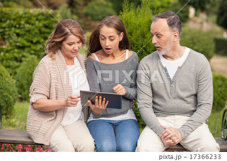 Pretty friendly family is using laptop for fun Pretty friendly family is using laptop for fun 17366233