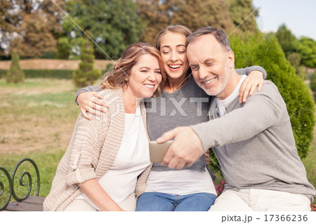Cheerful friendly family is making selfie in the nature Cheerful friendly family is making selfie in the nature 17366236