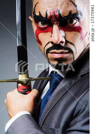 Man with face paint and sword Man with face paint and sword 17370981