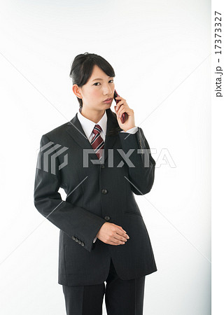 携帯電話で通話するビジネスウーマン 携帯電話で通話するビジネスウーマン 17373327