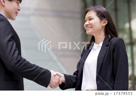 Young Asian business executives shaking hands Young Asian business executives shaking hands 17379555
