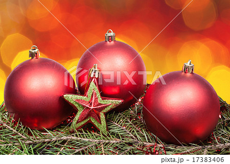 Xmas red bauble and star on blurred red background 17383406