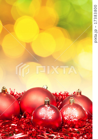 Xmas red bauble on blurred yellow green background 17383800
