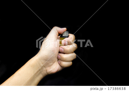 hold ligther in dark background 17386638