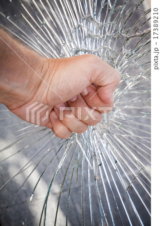 Strong male fist with broken glass Strong male fist with broken glass 17389210
