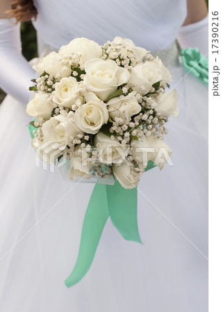 Bride Holding beautiful Bouquet of White Roses Bride Holding beautiful Bouquet of White Roses 17390216