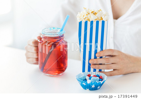 woman with popcorn and drink in glass mason jar woman with popcorn and drink in glass mason jar 17391449