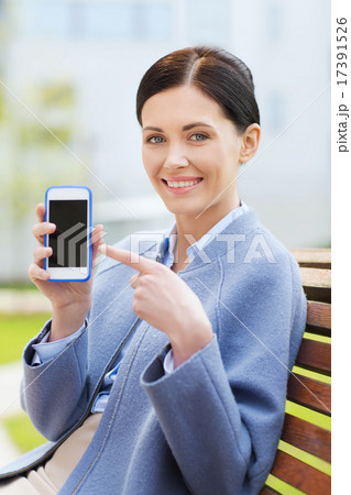 young smiling businesswoman showing smartphone young smiling businesswoman showing smartphone 17391526
