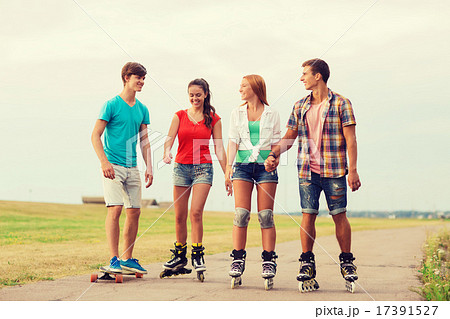group of smiling teenagers with roller-skates 17391527