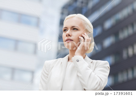 serious businesswoman with smartphone outdoors serious businesswoman with smartphone outdoors 17391601