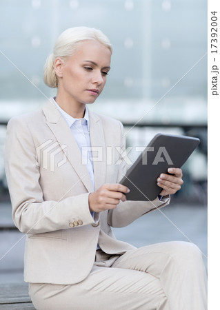 businesswoman working with tablet pc outdoors 17392004