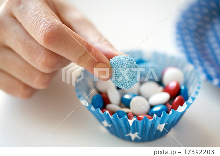 close up of hand with candies on independence day 17392203
