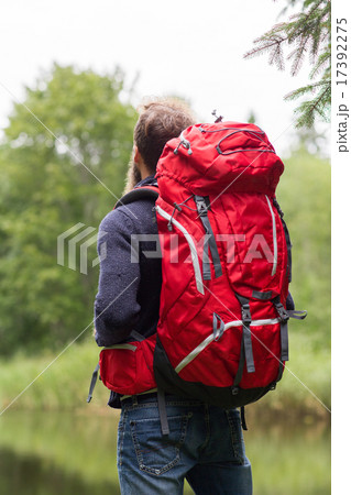 man with red backpack hiking 17392275