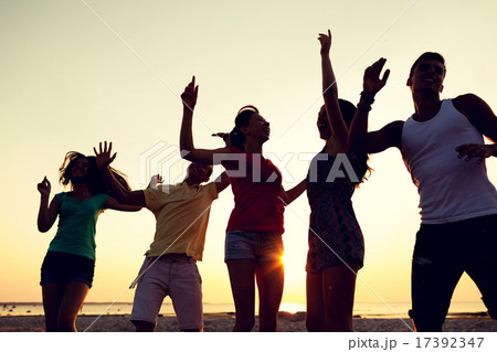 smiling friends dancing on summer beach smiling friends dancing on summer beach 17392347