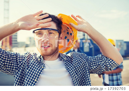 group of builders in hardhats outdoors group of builders in hardhats outdoors 17392703