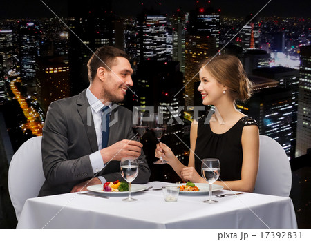 smiling couple eating main course at restaurant smiling couple eating main course at restaurant 17392831
