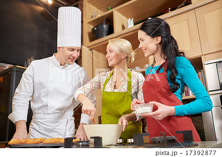 happy women and chef cook baking in kitchen 17392877